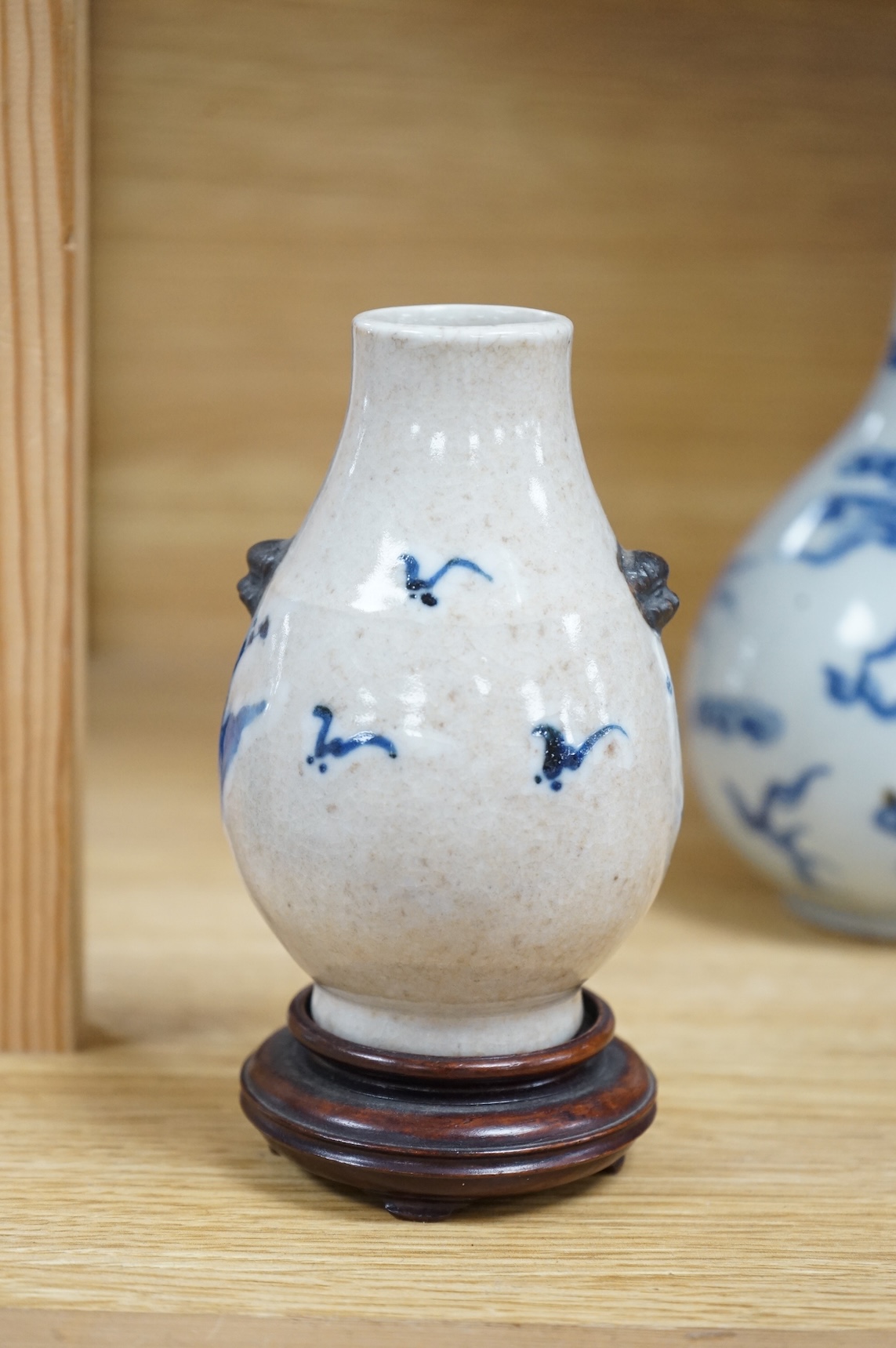 A Chinese blue and white bottle vase, a crackle glaze vase and a Tibetan copper and brass ‘monk’ cap’ ewer (3), tallest 21cm